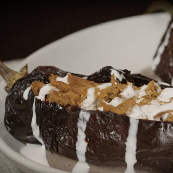 Platillo final de Chiles Anchos con Cochinita Pibil Chata servido en un plato blanco listo para disfrutar